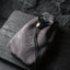 Veilhinge dark grey suede leather hip pouch with gothic embossed pattern and solid brass hardware on slate background