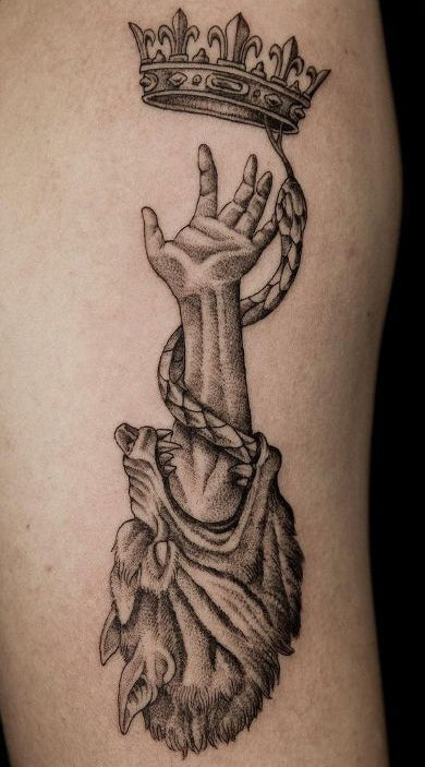 hand holding crown tattoo — crown as burden of leadership, earning power dark aesthetic tattoo symbolism