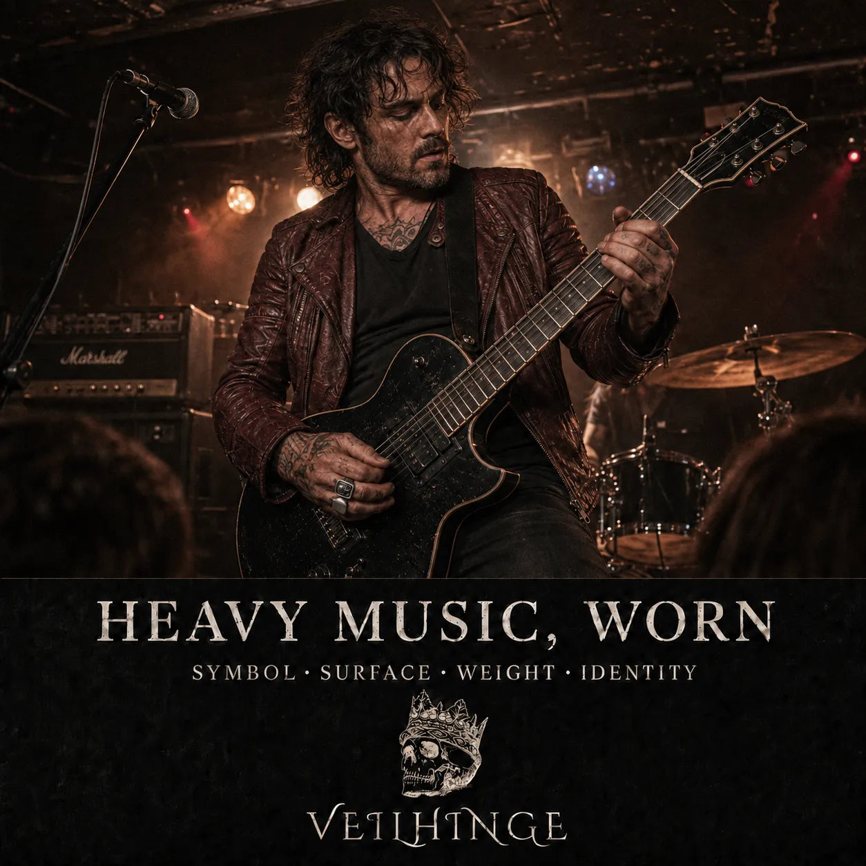 Rock guitarist wearing two silver signet rings while performing onstage at an intimate live music venue.