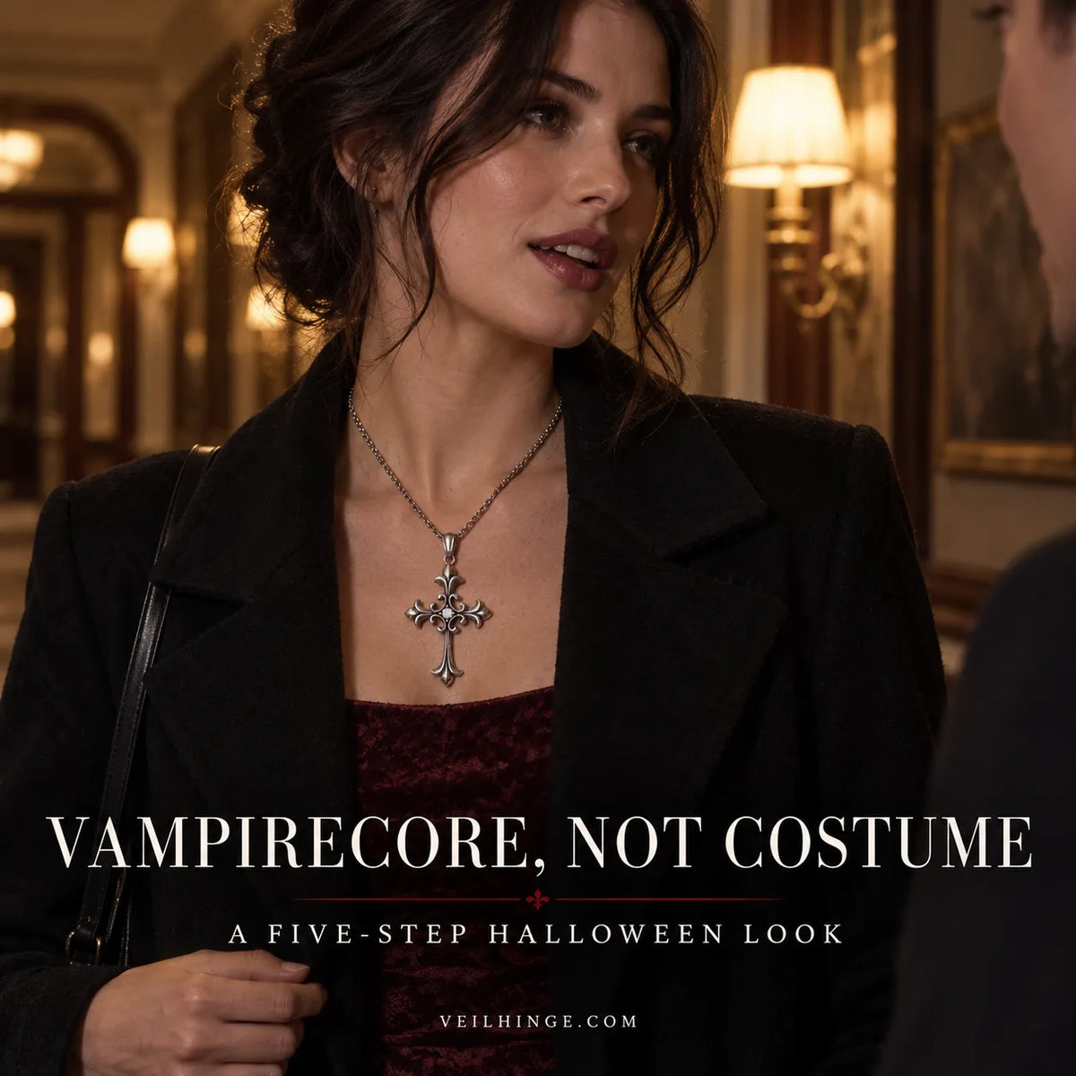 Woman wearing a restrained vampirecore outfit with a coffin pendant in a candlelit hotel setting.