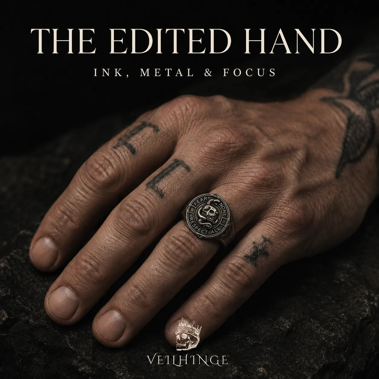 Dark oxidized signet ring creating a focal point on a tattooed hand, illustrating how metal changes the balance of ink, shape and light.