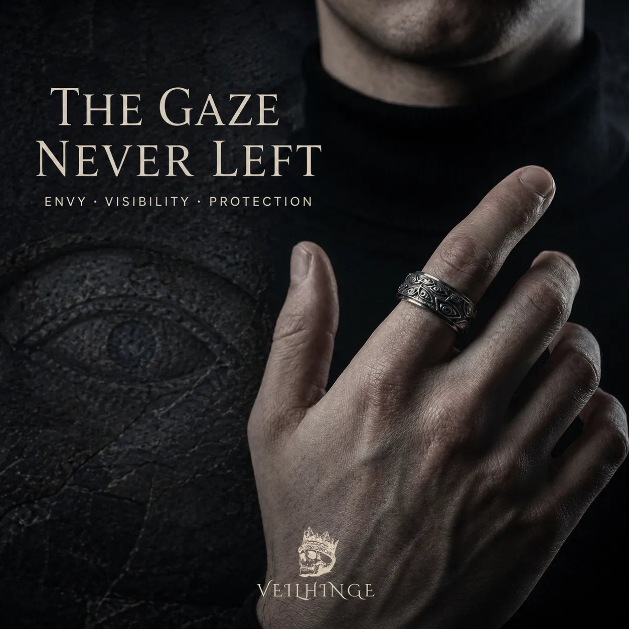 Hand wearing an oxidized silver evil eye ring beside a weathered eye carving under the title The Gaze Never Left.