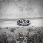 Crown of thorns band ring flat lay showing thorn wreath structure in oxidized black stainless steel, gothic dark aesthetic stackable ring by Veilhinge