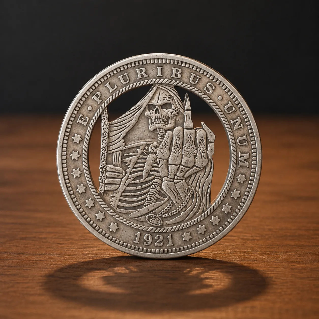 A round silver-toned commemorative coin featuring a grim reaper design, standing upright on a wooden surface against a dark background.