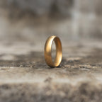 Antique gold-tone plain band ring standing upright in side view