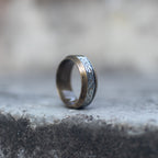 Side view of an antique gold-tone Viking ring engraved with runes and Celtic knots