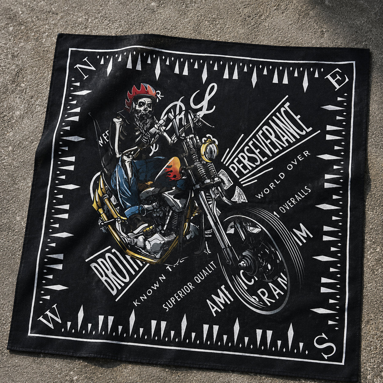 Black bandana laid flat showing a skull riding a motorcycle with compass border and text reading Brotherhood, Perseverance, American Made