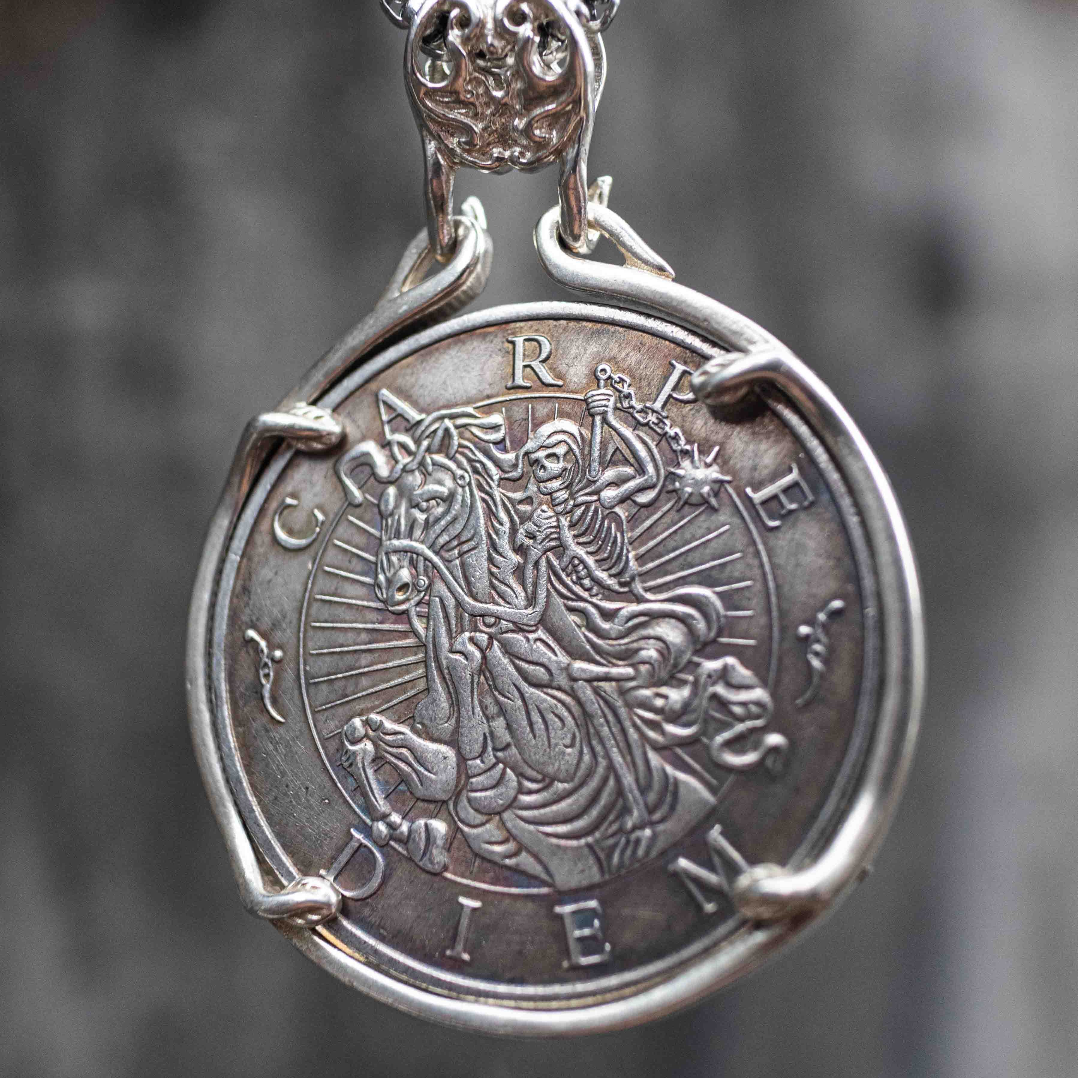 Reverse side of coin pendant showing Carpe Diem grim reaper on horseback engraving, set in silver bezel mount