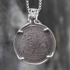 Coin pendant engraved with a festive woman in a Christmas hat beside a decorated tree and fireplace, diamond floor pattern, dated 1881, set in a four-prong bezel on a chain