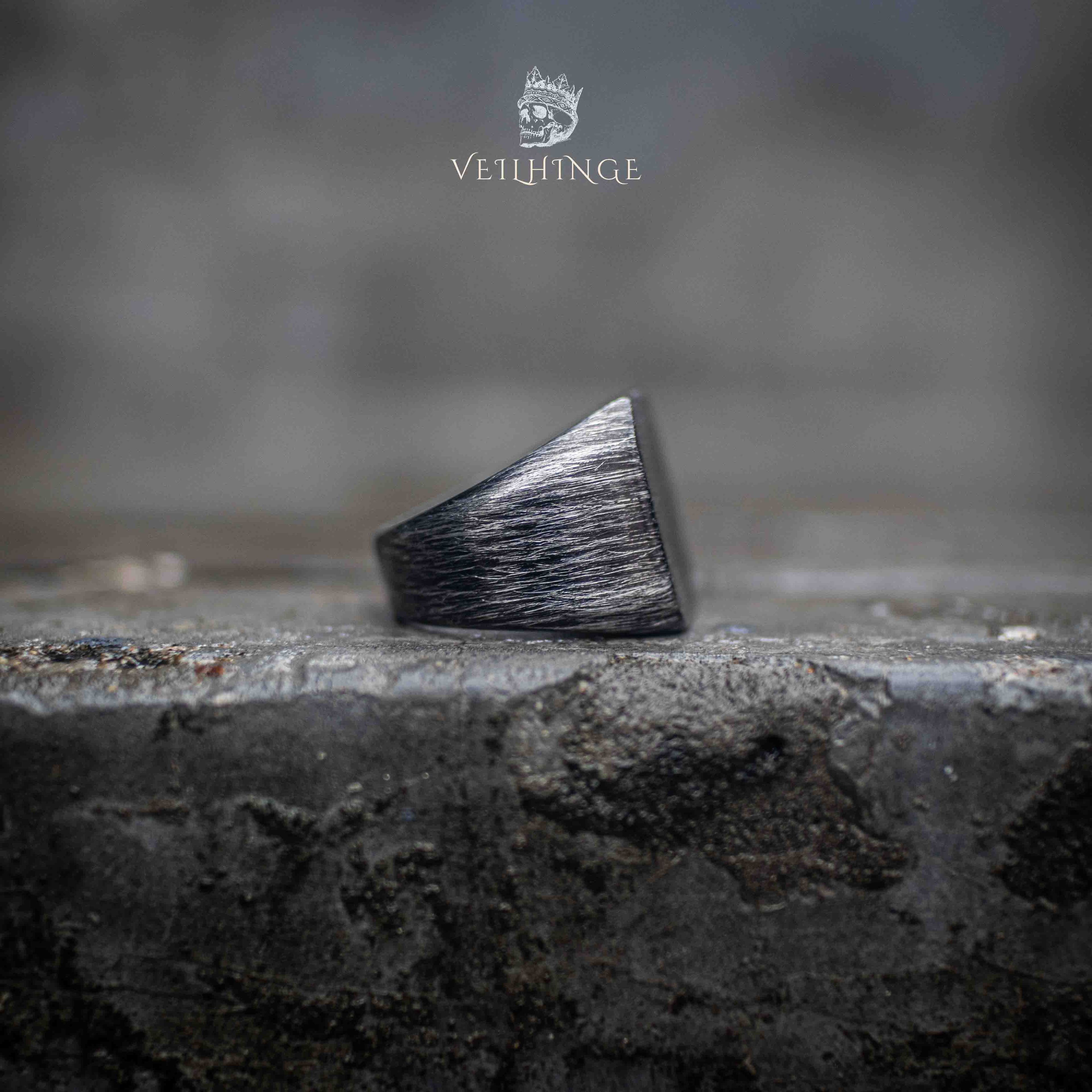 dark oxidized square band ring from opposite angle — clean angular form with brushed surface detail on rough stone