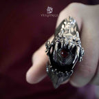Demon eye armor ring with the eye fully open as the finger bends, dark claw frame revealing the eye at the center of the ring face