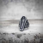Dracula coffin ring with cloaked vampire figure engraving in oxidized antique silver stainless steel, baroque scroll side detail, vampirecore gothic statement ring by Veilhinge, front view