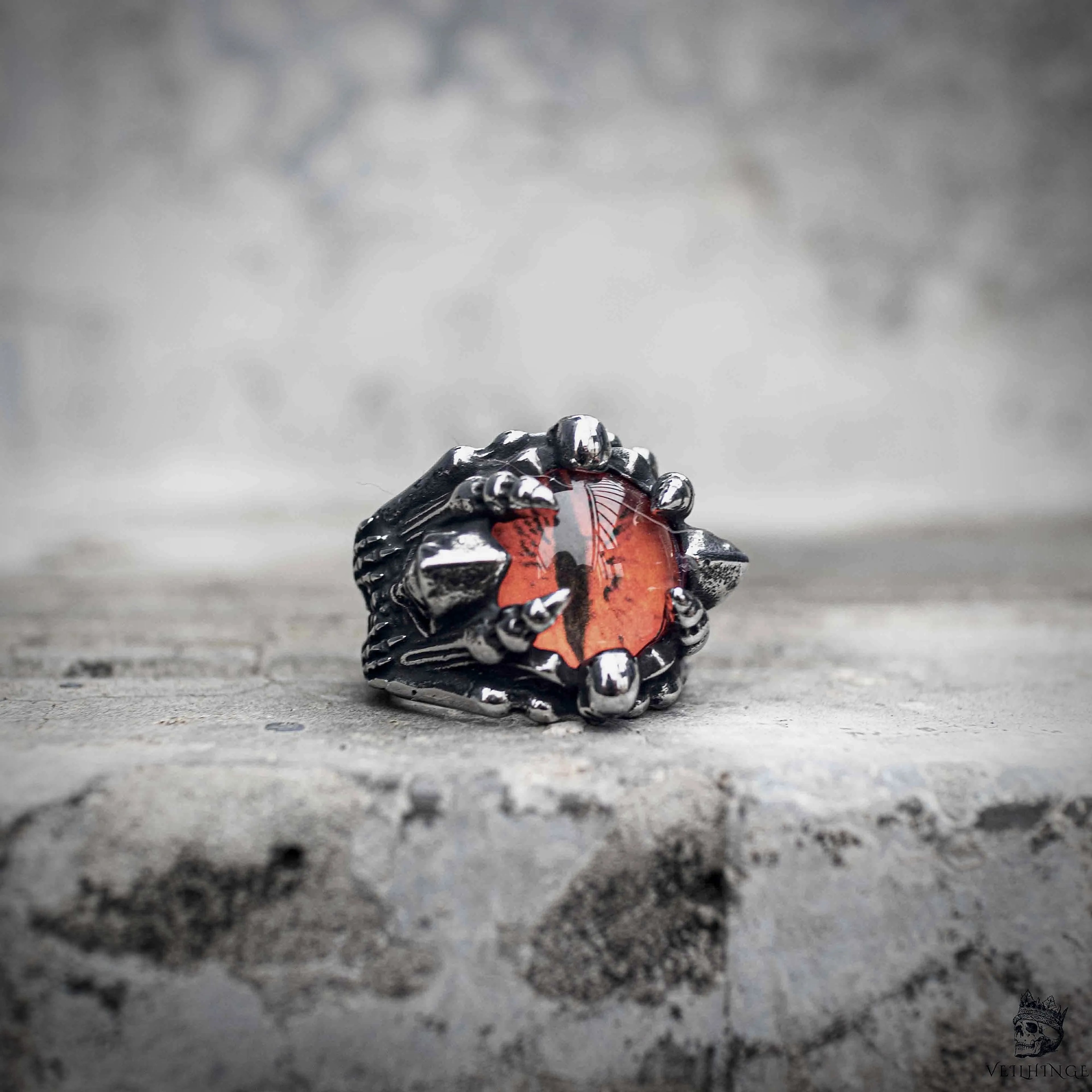 Dragon claw ring with orange red gemstone setting in oxidized silver stainless steel, gothic dark aesthetic statement ring by Veilhinge, front view