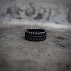 Dragon scale band ring flat lay in oxidized black stainless steel, dark aesthetic gothic ring by Veilhinge, top view