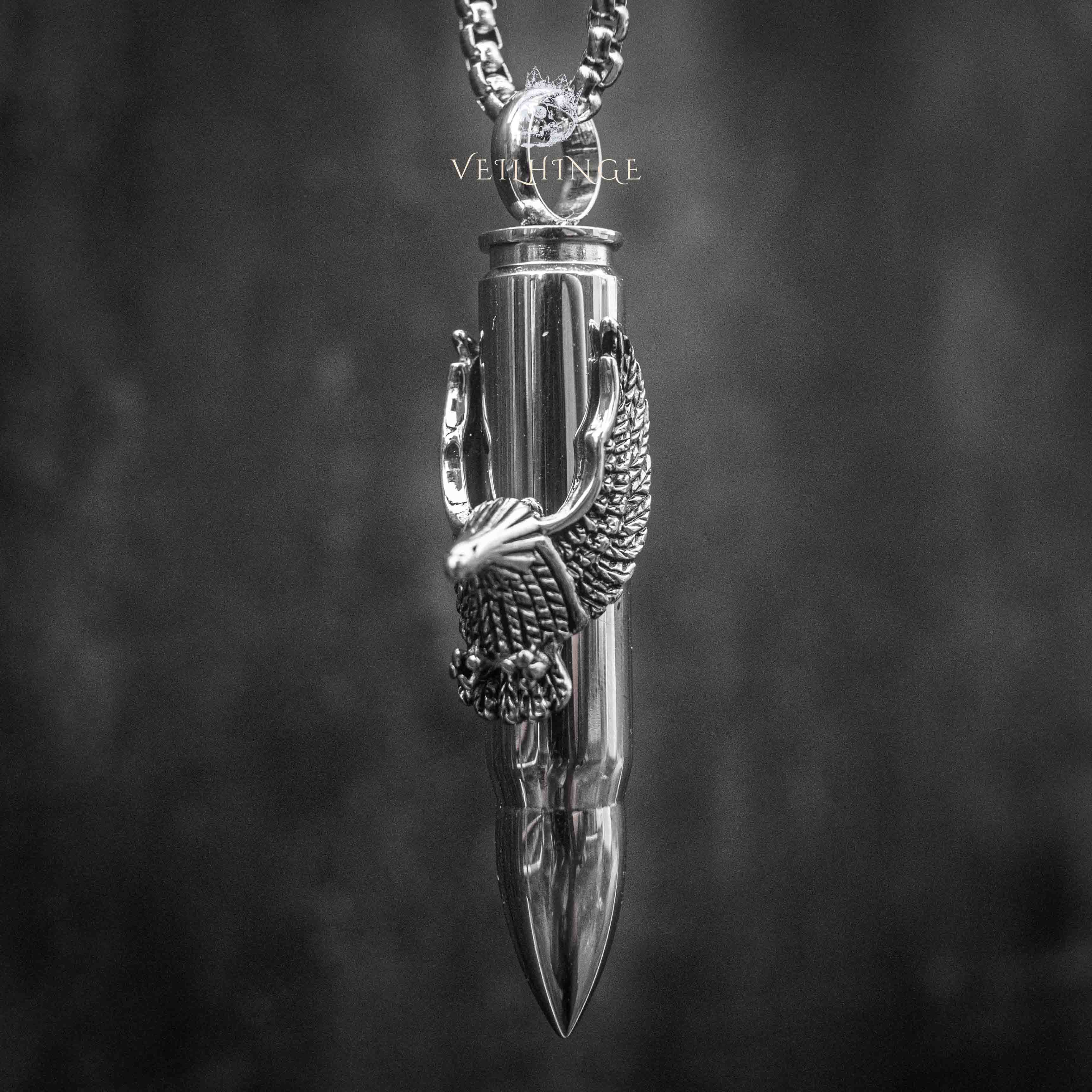 eagle claw bullet pendant necklace — polished silver bullet gripped by eagle talons, full chain view on dark background