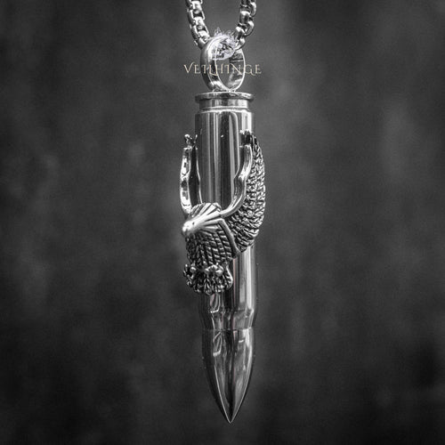 eagle claw bullet pendant necklace — polished silver bullet gripped by eagle talons, full chain view on dark background