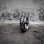 Evil eye spinner ring with rotating oxidized silver band engraved with all-seeing eye pattern, dark aesthetic stainless steel anxiety ring by Veilhinge, upright view