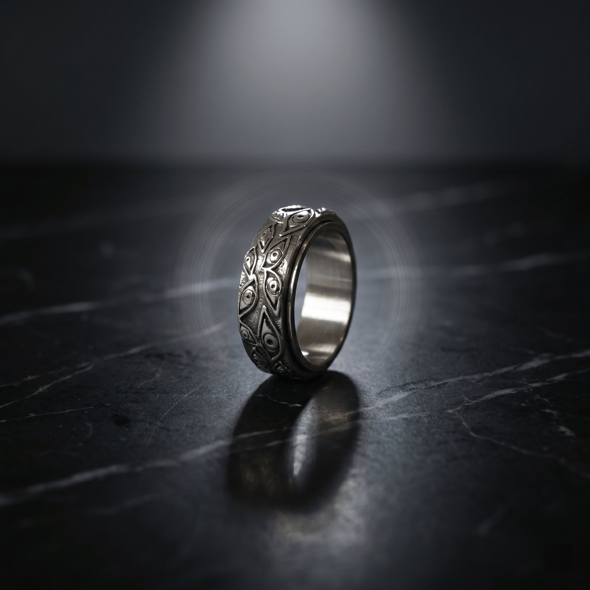 rotating stainless steel ring with dark eye motif detail