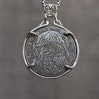 Coin pendant engraved with the Evil Queen witch holding a poison apple, set in a four-prong open bezel with skull bail on a box chain