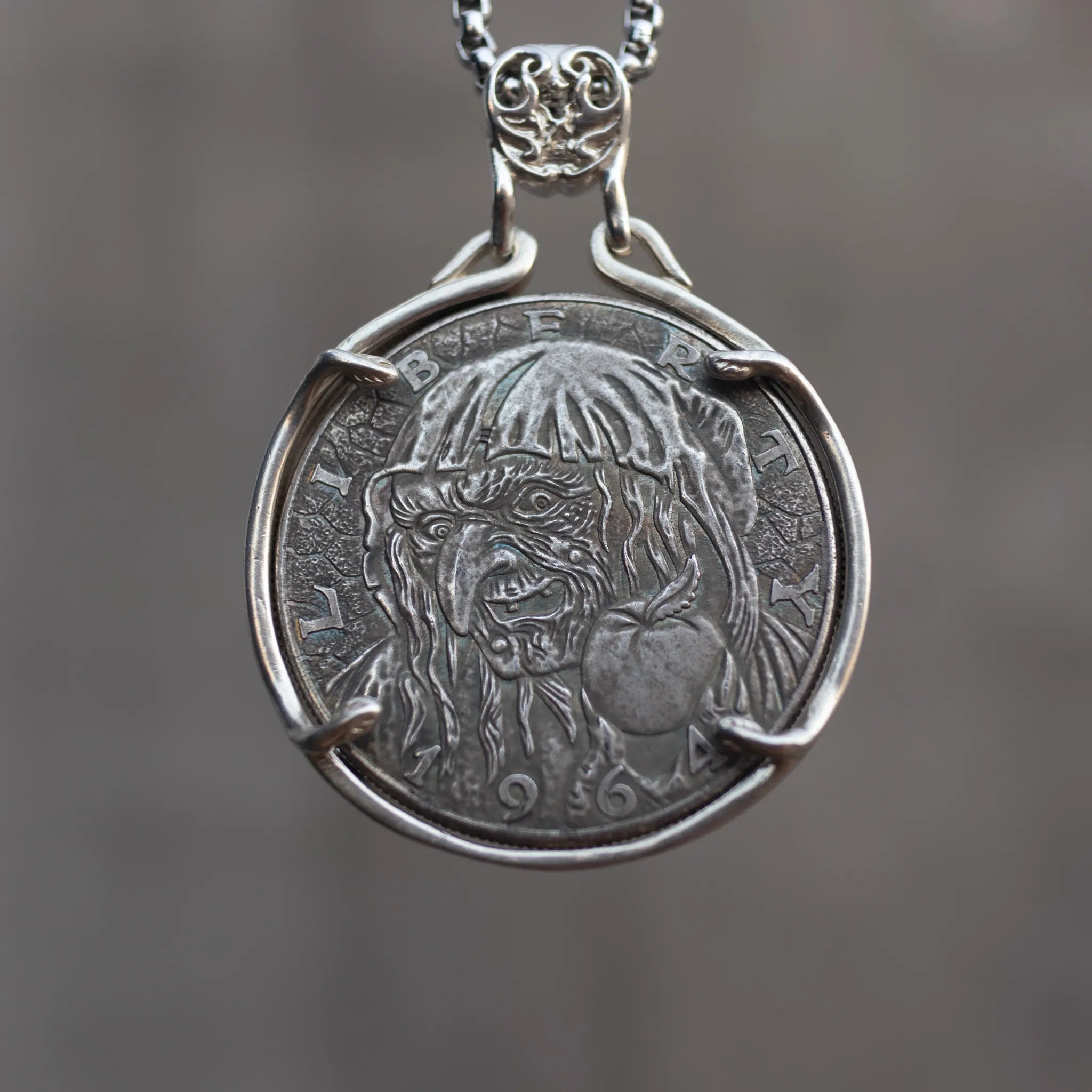 Coin pendant engraved with the Evil Queen witch holding a poison apple, set in a four-prong open bezel with skull bail on a box chain