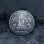Close-up of a coin engraved with the Eye of Providence triangle, standing human figure, flanking deer and wolf, beehive at base, scrollwork border