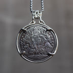 Coin pendant engraved with the Eye of Providence triangle above a standing figure flanked by animals and a beehive, set in a four-prong bezel on a chain