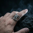 Close-up of hand wearing the Facehugger alien ring with dramatic smoke and dark background