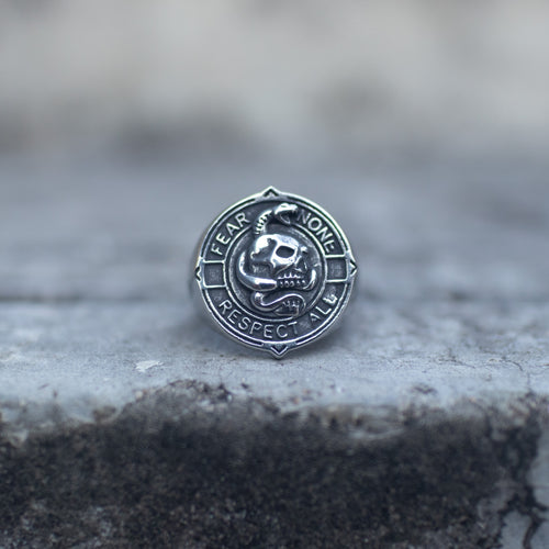 Silver-tone skull signet ring engraved with Fear None Respect All, front view