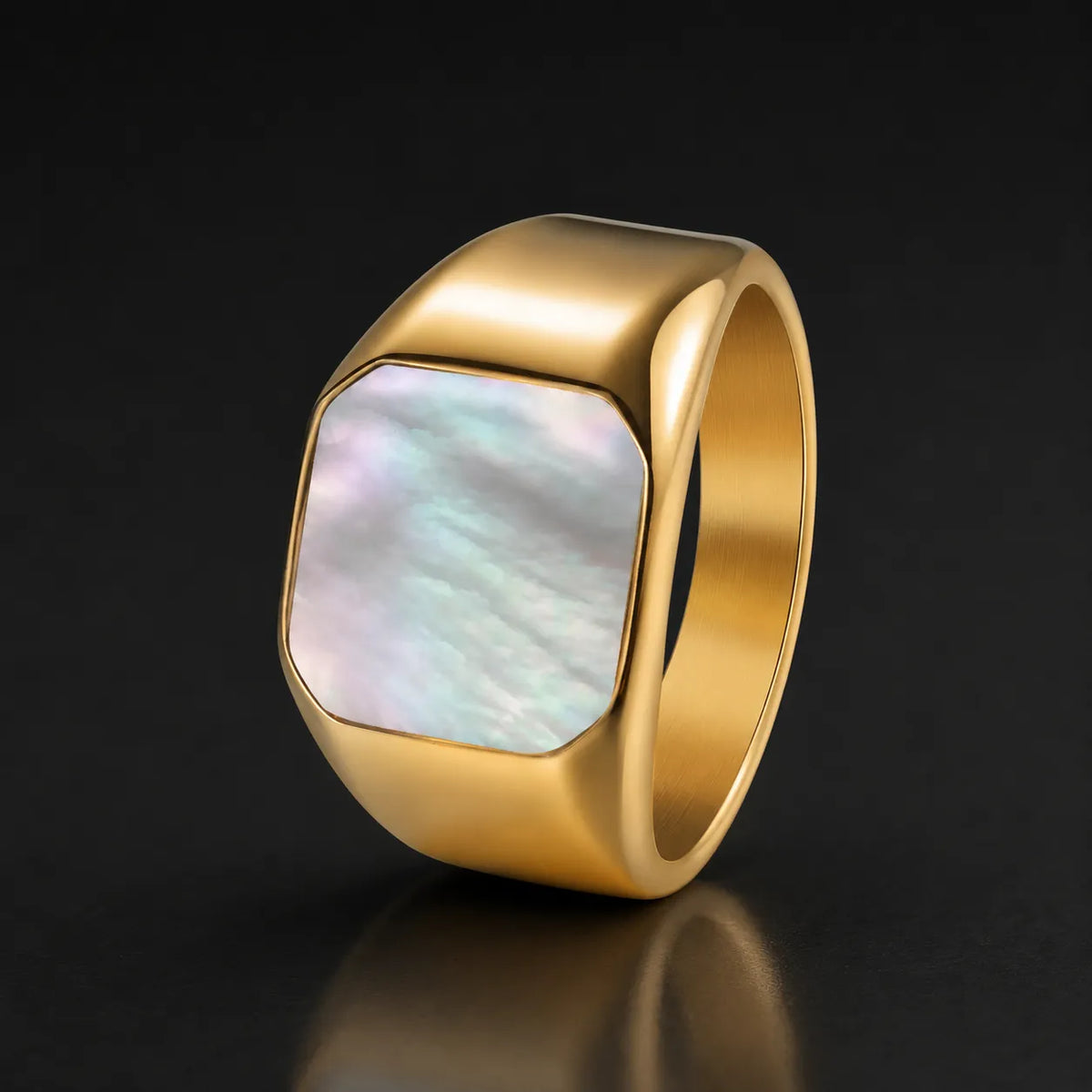 Gold-tone square signet ring with iridescent mother-of-pearl inlay on a black reflective background