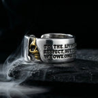 Gothic Voltaire skull ring with gold skull and engraved quote on dark rock with smoke
