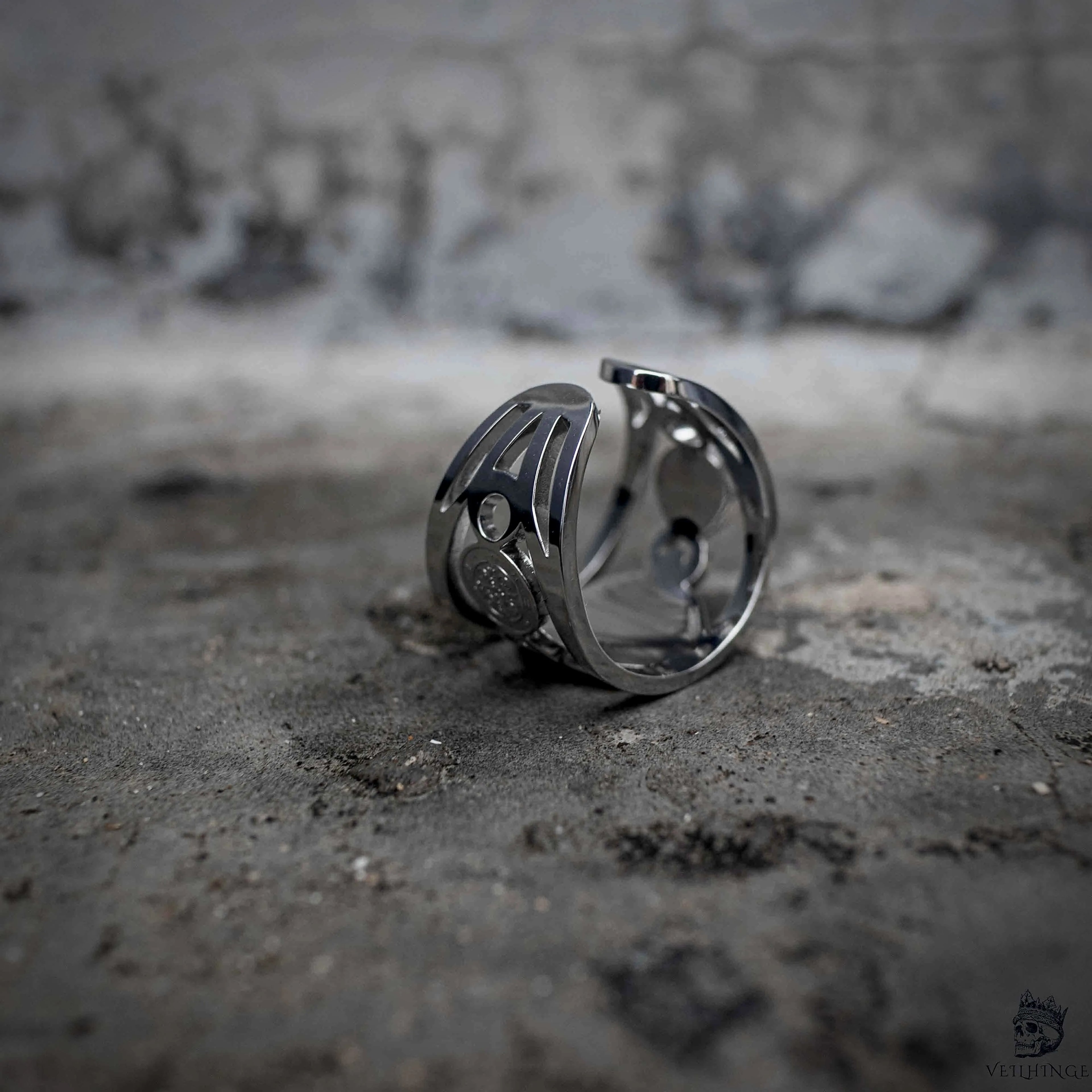 Gothic wide band ring with openwork cutout design in polished stainless steel, dark aesthetic jewelry, angled back view, Veilhinge