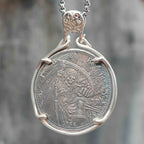 Coin pendant engraved with a winged Grim Reaper holding a scythe and hourglass with a skull at its feet, Liberty inscription, dated 1936, set in a four-prong bezel on a chain