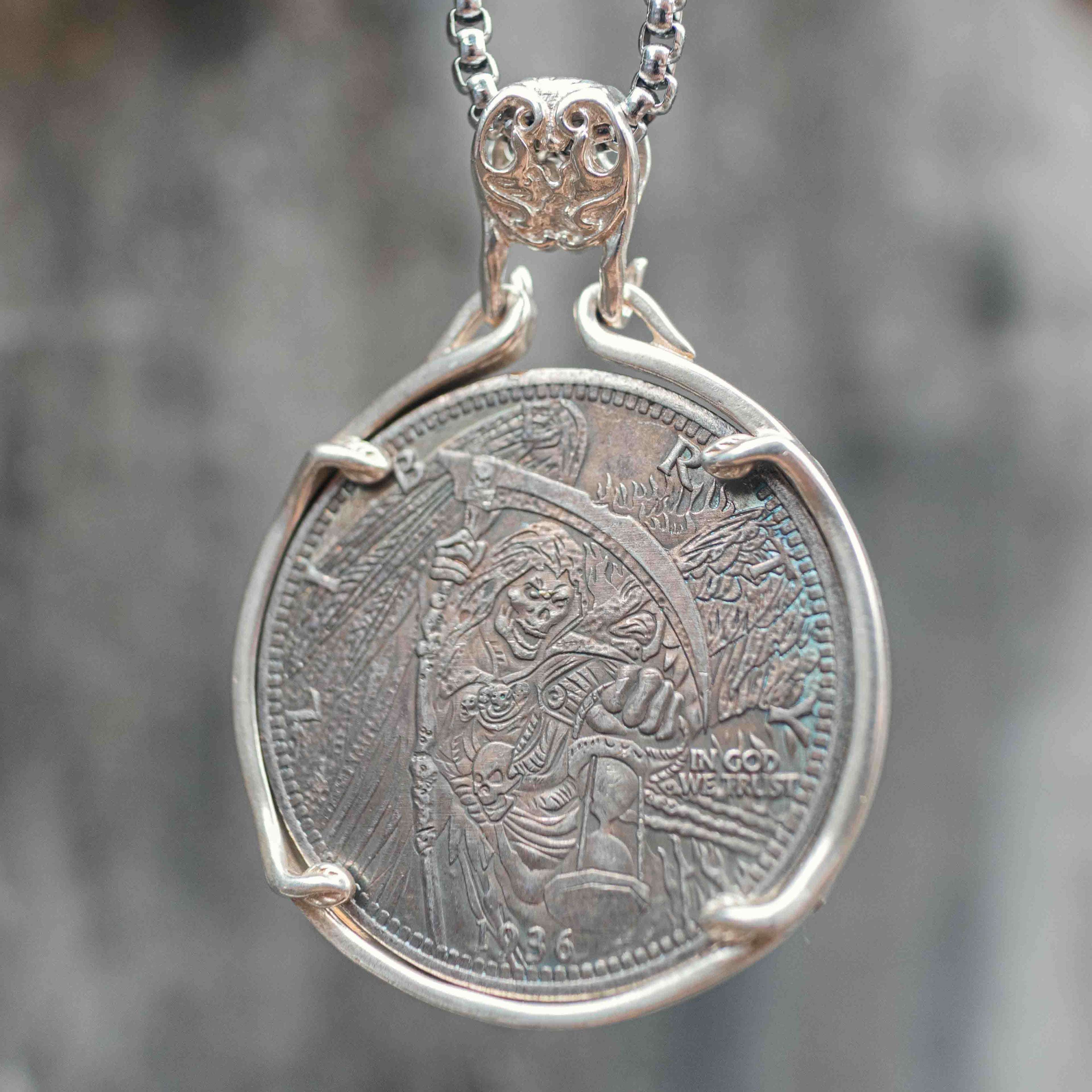 Coin pendant engraved with a winged Grim Reaper holding a scythe and hourglass with a skull at its feet, Liberty inscription, dated 1936, set in a four-prong bezel on a chain