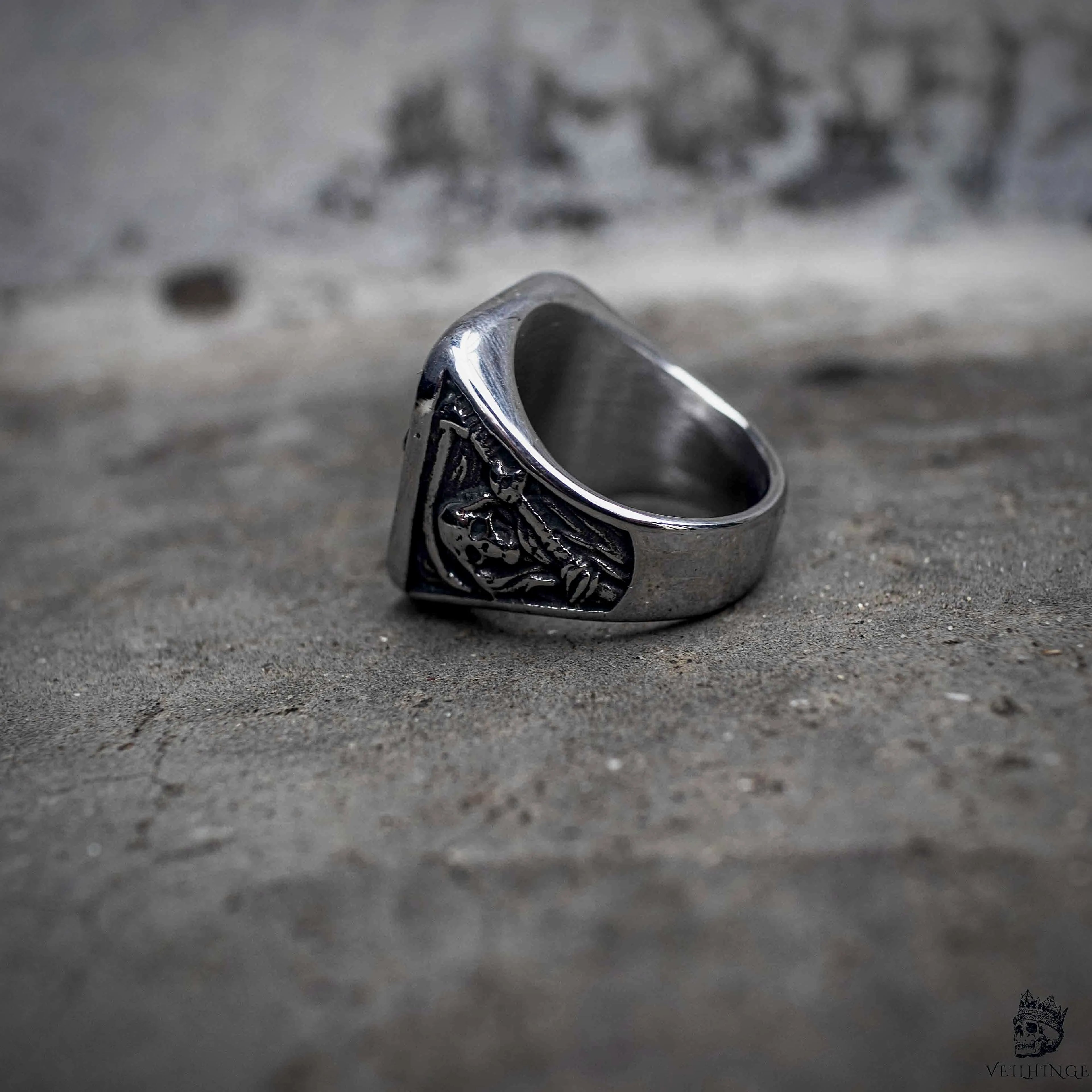 Grim reaper signet ring side view showing polished stainless steel band and engraved face detail, gothic dark aesthetic ring by Veilhinge