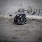 Grim reaper signet ring with square face and oxidized skull side detail, dark aesthetic stainless steel jewelry by Veilhinge, front view