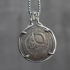 Coin pendant engraved with a Spanish conquistador in a morion helmet and armor, Medio Balboa inscription, set in a four-prong bezel on a decorative chain