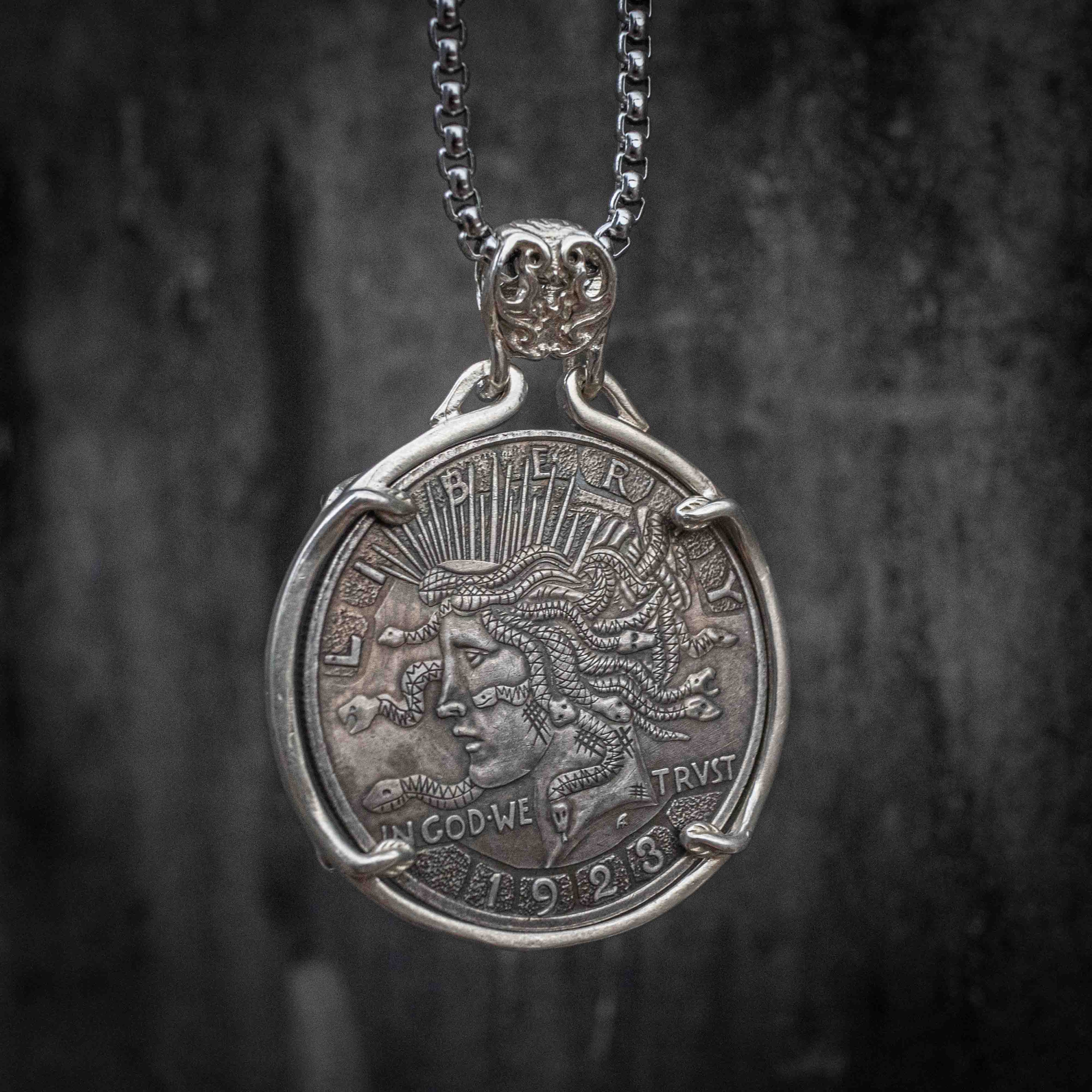 Coin pendant engraved with Medusa in profile with flowing snake hair, Liberty and In God We Trust inscriptions, dated 1923, set in a four-prong bezel on a chain