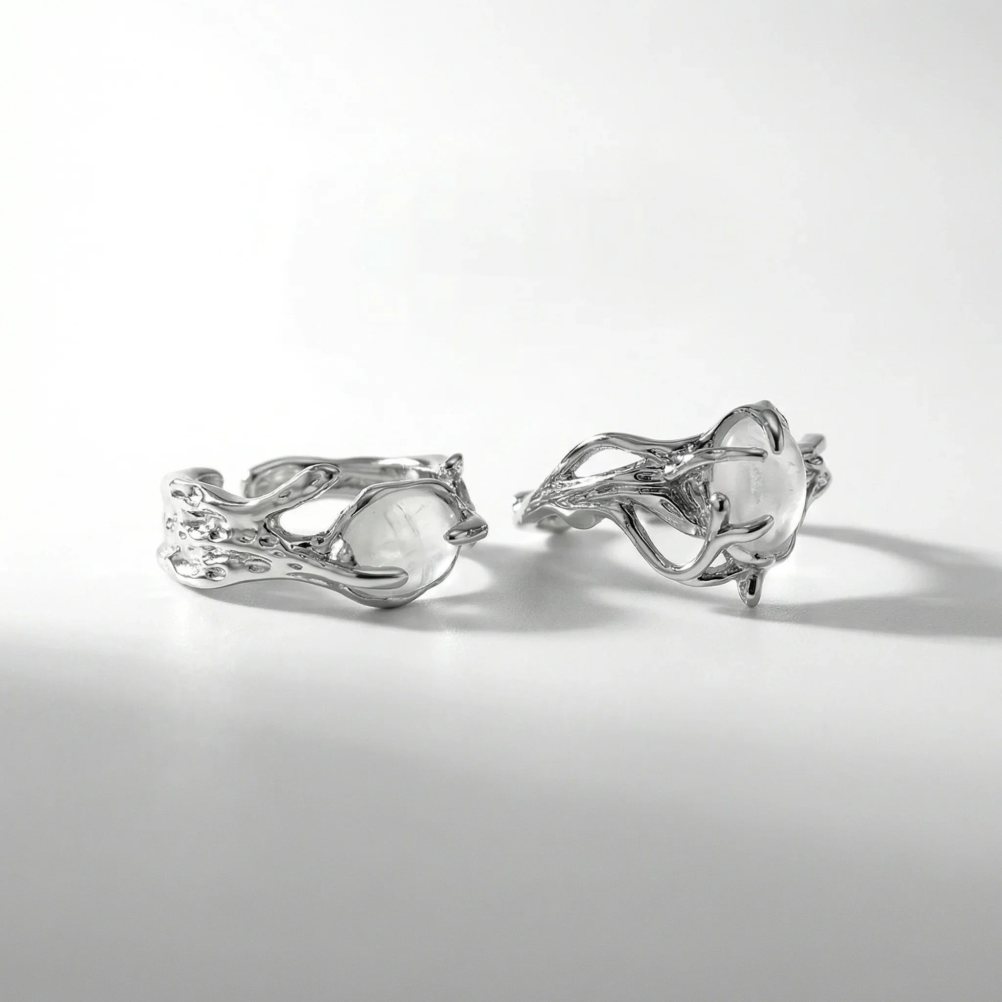 Two silver organic moonstone rings shown from multiple angles on clean white background, highlighting intricate tentacle design