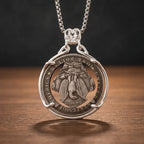 biker skull coin pendant necklace reverse — american eagle coin face, United States of America inscription, antique silver tone, dark wood surface
