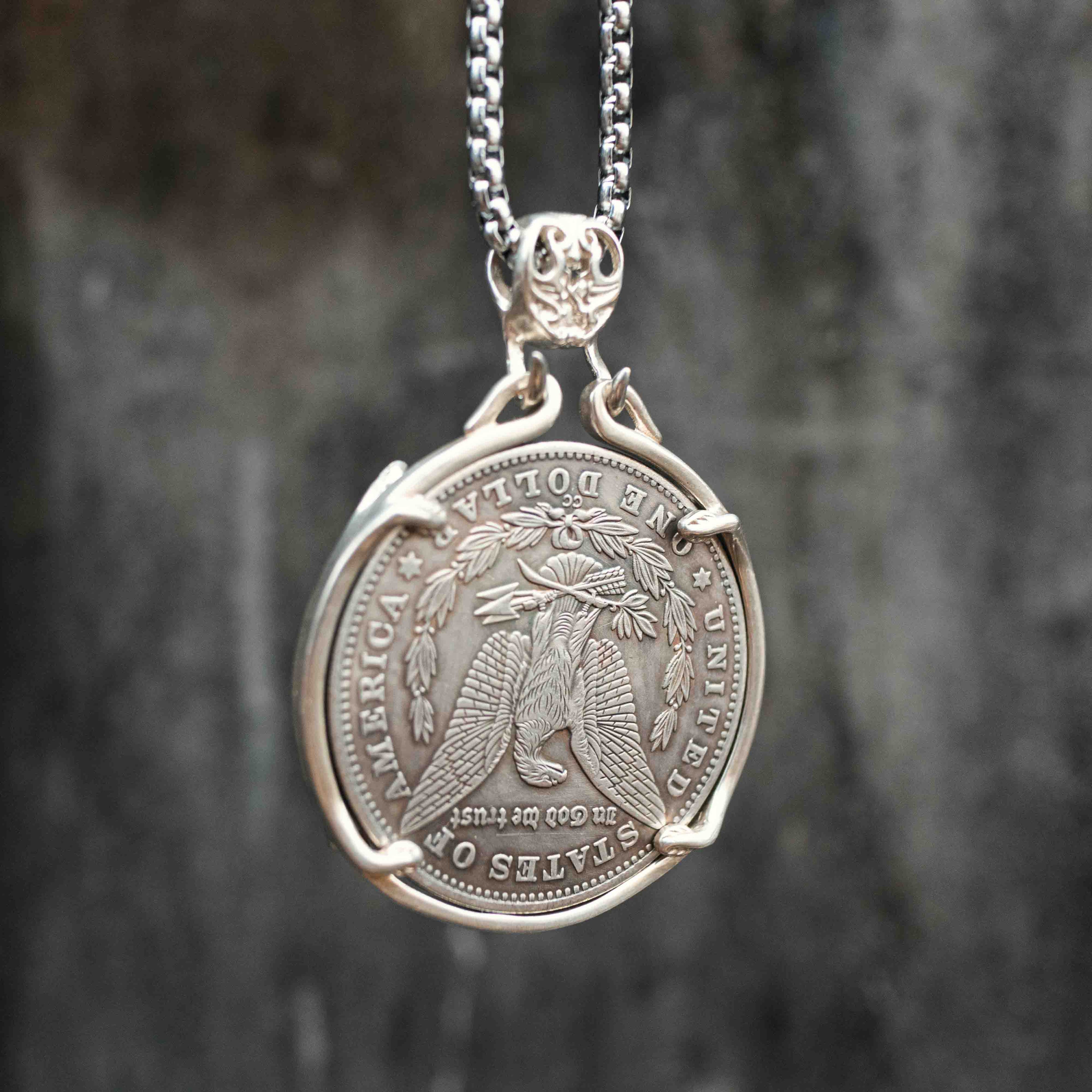 All-seeing eye coin pendant reversed to show the Morgan Dollar eagle with United States of America and One Dollar inscription, in a four-prong open bezel on a chain
