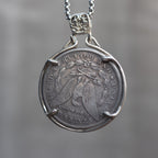 Morgan Dollar reverse showing the American eagle with spread wings, In God We Trust, United States of America, and One Dollar denomination on dark stone