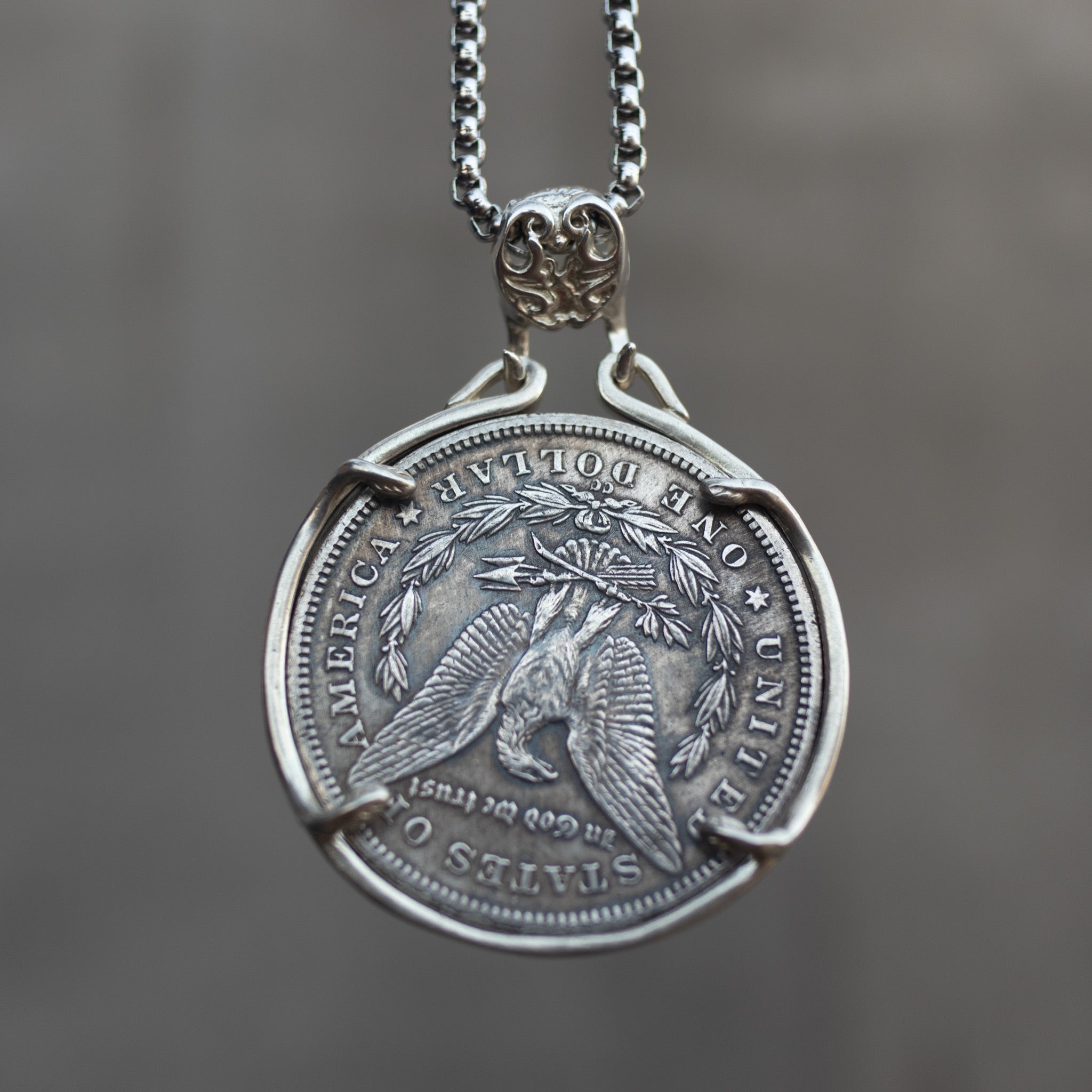 Dapper cat coin pendant reversed to show the Morgan Dollar eagle with One Dollar inscription, held in a four-prong open bezel on a chain