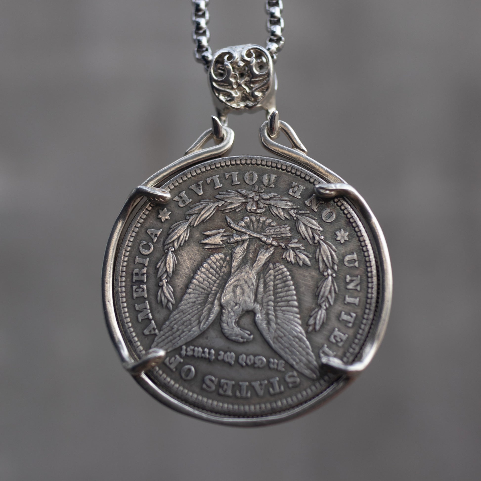 Medio Balboa conquistador coin pendant reversed to show the Morgan Dollar eagle with United States of America and One Dollar inscription, in a four-prong open bezel