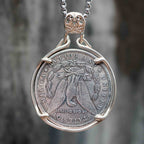 Plague doctor coin pendant reversed to show the Morgan Dollar eagle with United States of America and One Dollar inscription, in a four-prong open bezel
