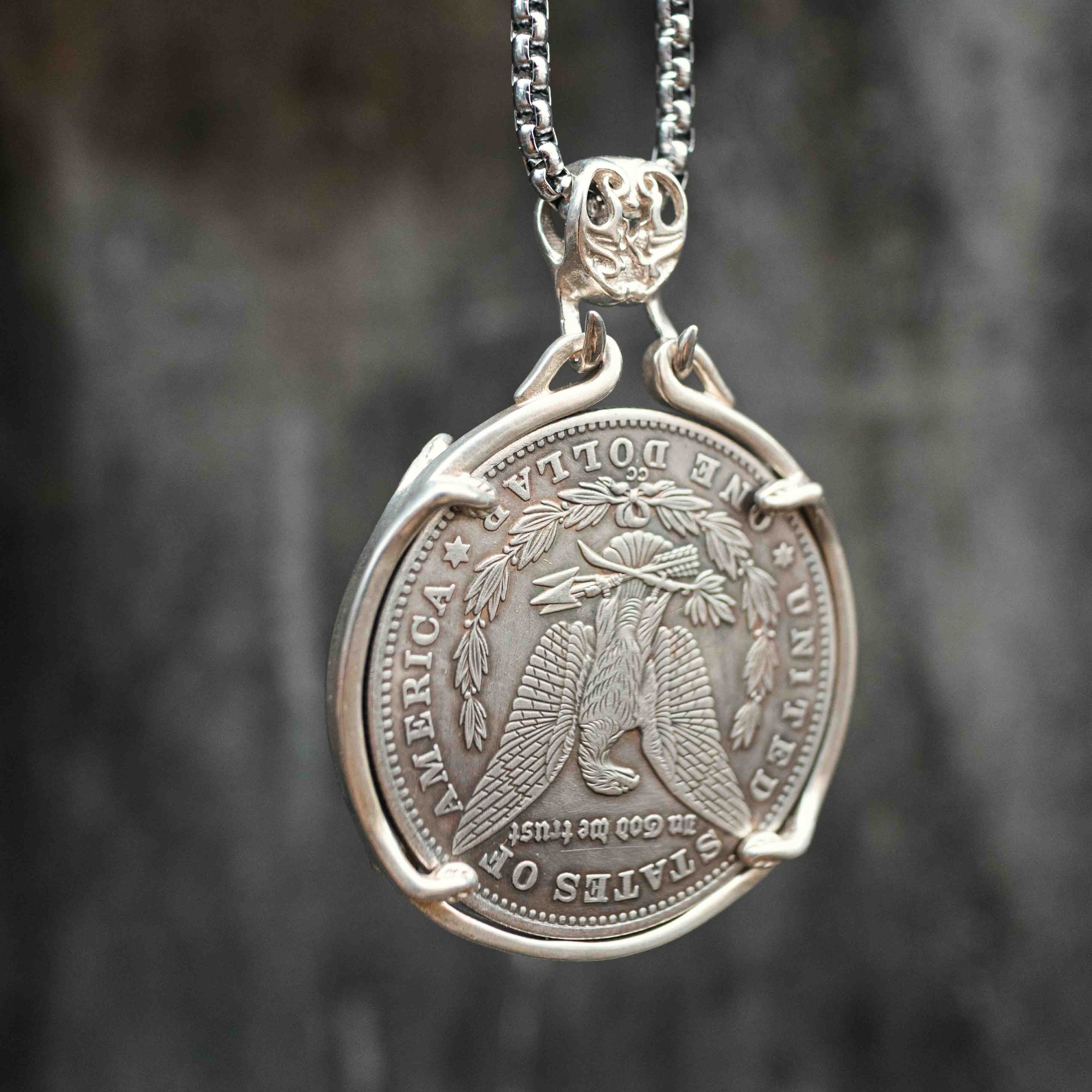 Skeleton gambler coin pendant reversed to show the Morgan Dollar eagle with United States of America and One Dollar inscription, in a four-prong open bezel