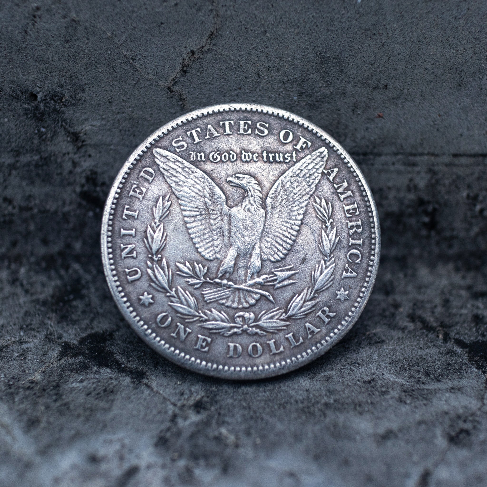 Cthulhu skull tentacle coin pendant reversed to show the Morgan Dollar eagle with United States of America and One Dollar inscription, in a four-prong open bezel