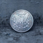 Morgan Dollar reverse with American eagle, In God We Trust inscription, and One Dollar denomination, reverse side of the Evil Queen witch coin