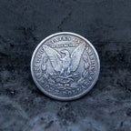 Morgan Dollar reverse with American eagle, In God We Trust inscription, United States of America border, and One Dollar denomination