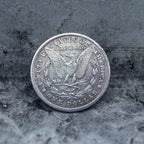 Morgan Dollar reverse showing the American eagle with In God We Trust inscription and olive branch, One Dollar coin back face