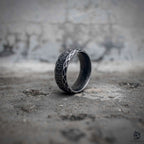 Norse rune band ring with serpent scale engraving and polished stainless steel interior in oxidized black finish, Viking dark aesthetic ring by Veilhinge, side view